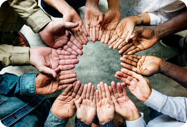 Community members joining hands around a circle